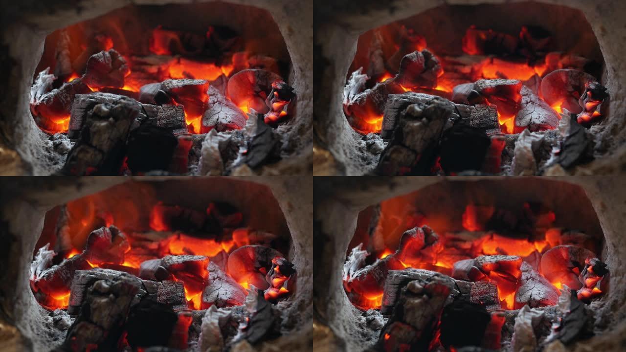 壁炉中白炽燃烧的煤的特写镜头，烧烤的热煤火和冬季圣诞节假期概念。