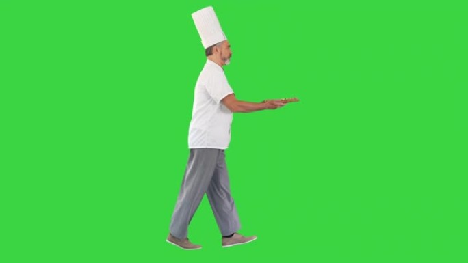 厨师在绿色屏幕上匆匆忙忙地拿着披萨走，色度键