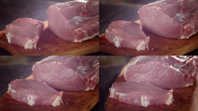 生一块猪肉在切菜板上慢慢旋转。