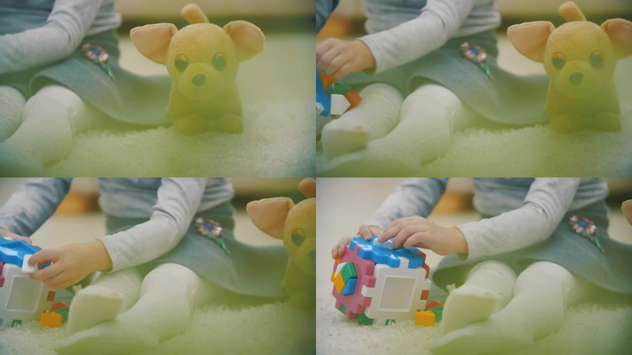 4k慢动作视频，婴儿在地毯上玩彩色金字塔。