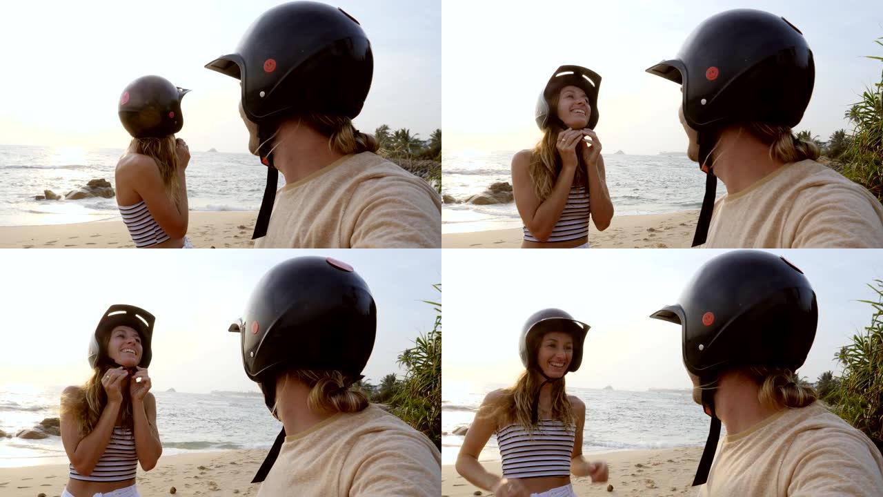 沙滩上情侣在骑踏板车前调整头盔的视点。人们在日落时分旅行，享受斯里兰卡的热带气候。慢动作