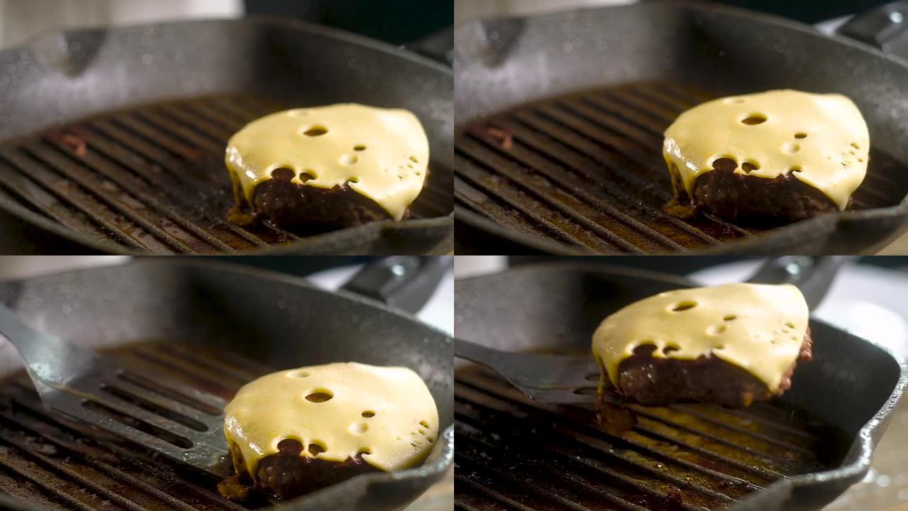 大厨抹刀用煎锅烤架捡起多汁的肉饼和脆皮