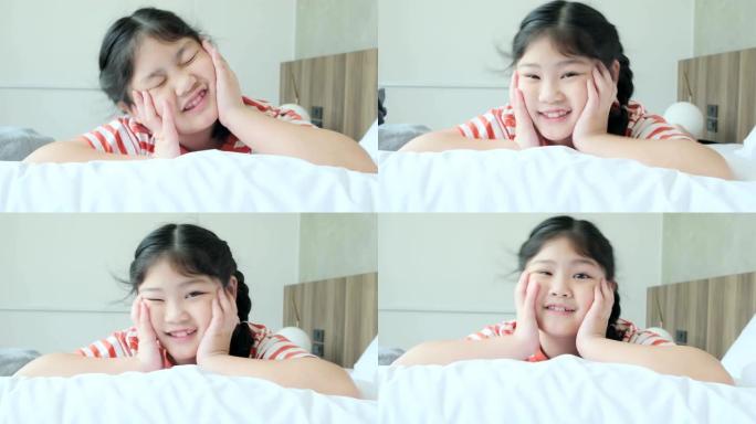可爱漂亮的年轻亚洲女性休闲布舒适有趣的游戏与快乐和快乐在白色软床4k慢动作镜头