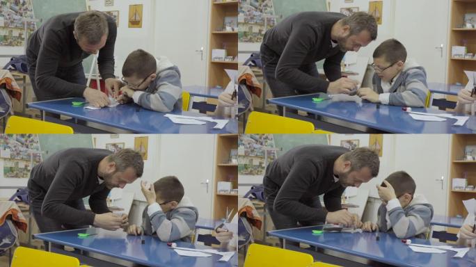老师协助智障男孩胶水几何形状切出