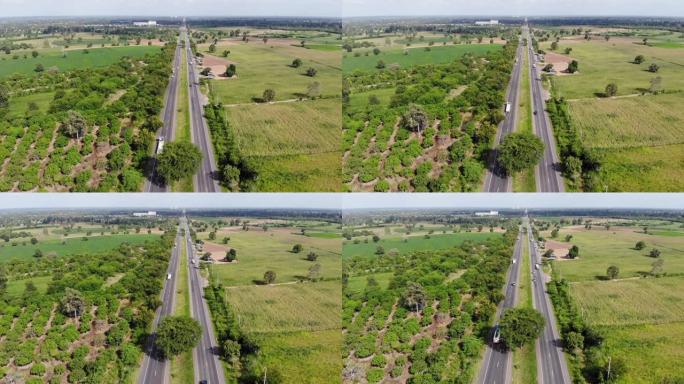 鸟瞰图乡村公路交通的风景景观，道路上有汽车和卡车，无人机拍摄