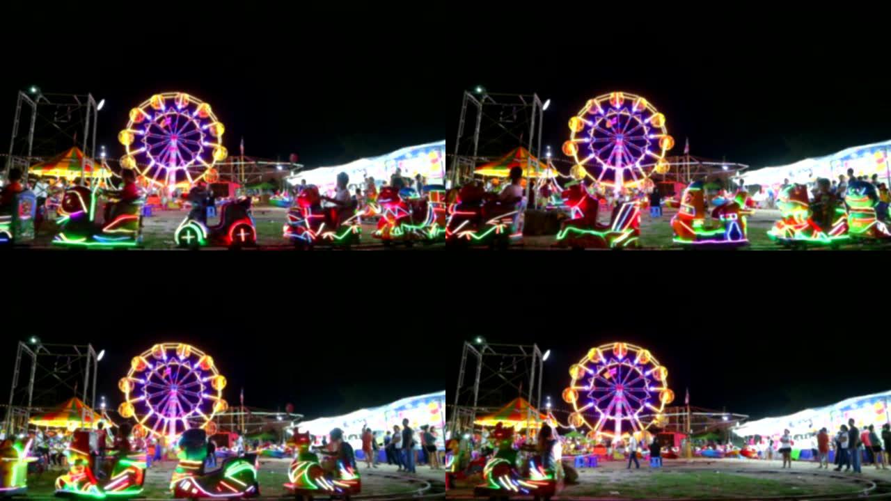 夜市博览会1中的模糊旋转木马和摩天轮以及火车的霓虹灯