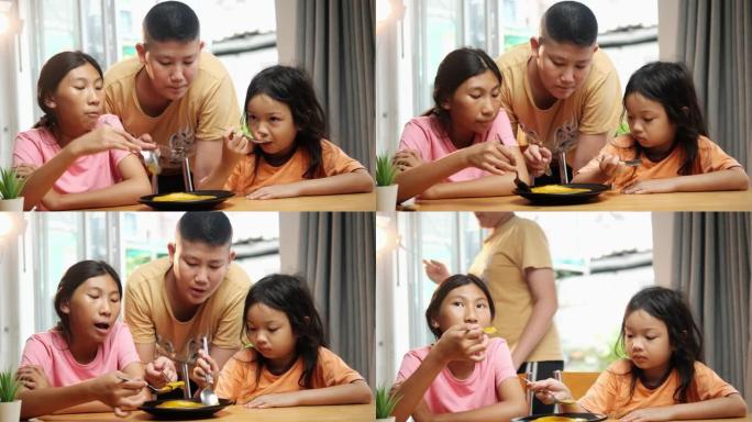 亚洲孩子在家一起吃自制明胶甜食，生活方式理念。