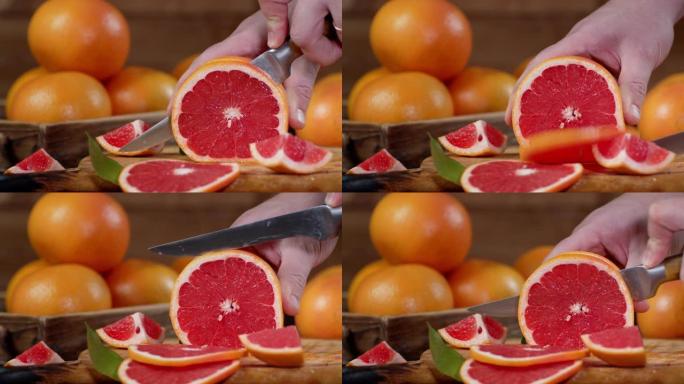 男性用刀将柚子切成薄片。