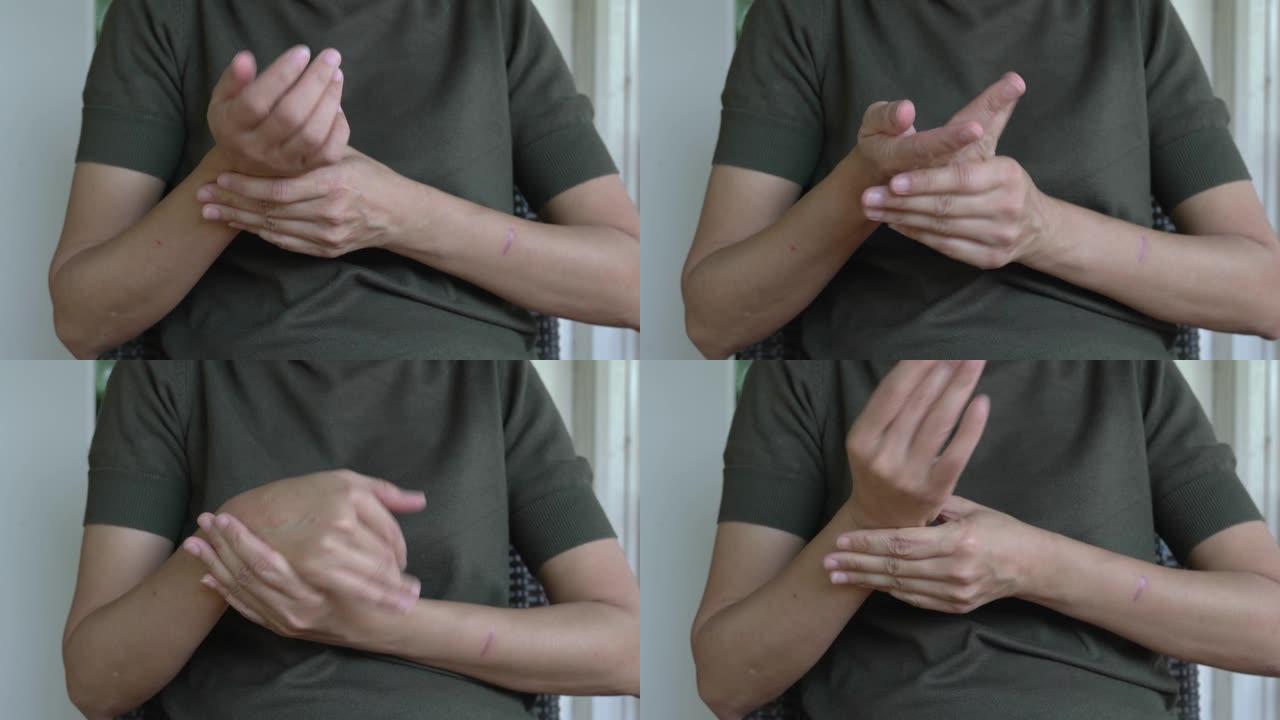 手腕疼痛。女人的手触摸手腕并试图拉伸关节。关节炎、肌腱炎、关节痛概念。特写视图。