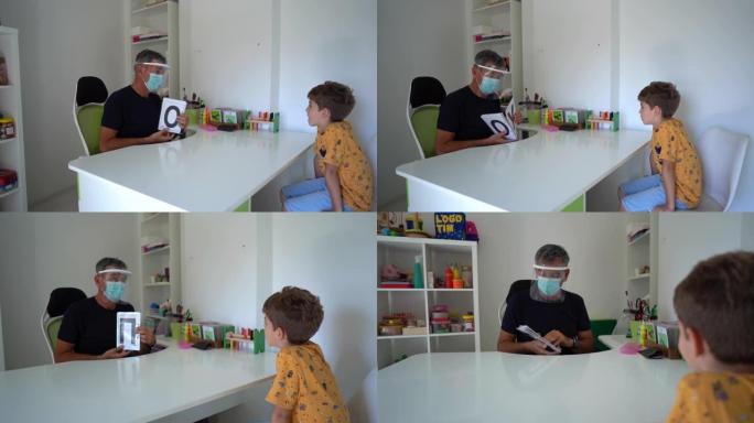 小男孩在言语治疗师办公室学习发音