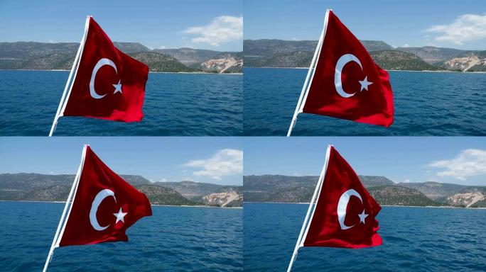 在阳光明媚的日子里，土耳其国旗在风中挥舞着地中海。