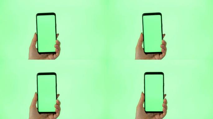 绿屏手机女人使用智能手机。女性手触摸，点击，点击，滑动，拖动和滑动色度键绿色屏幕背景