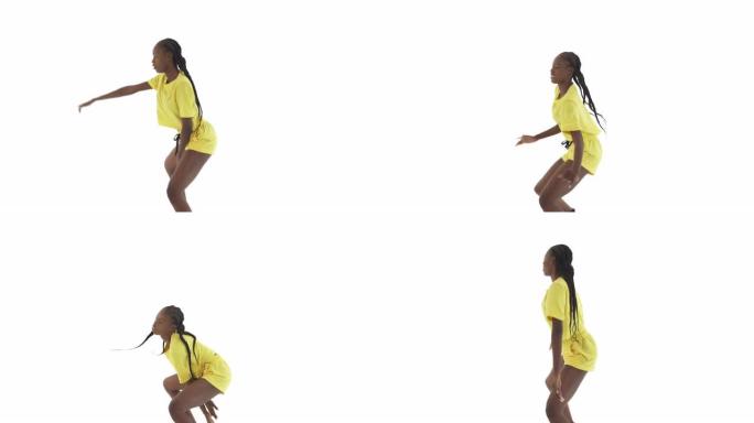 低蹲姿势跳舞的非洲妇女的侧视图。性感的动作。孤立在白色背景上。