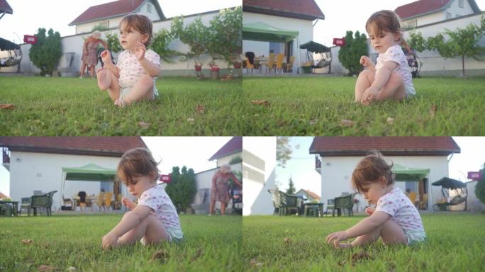 可爱的无辜女婴在后院的草地上玩耍