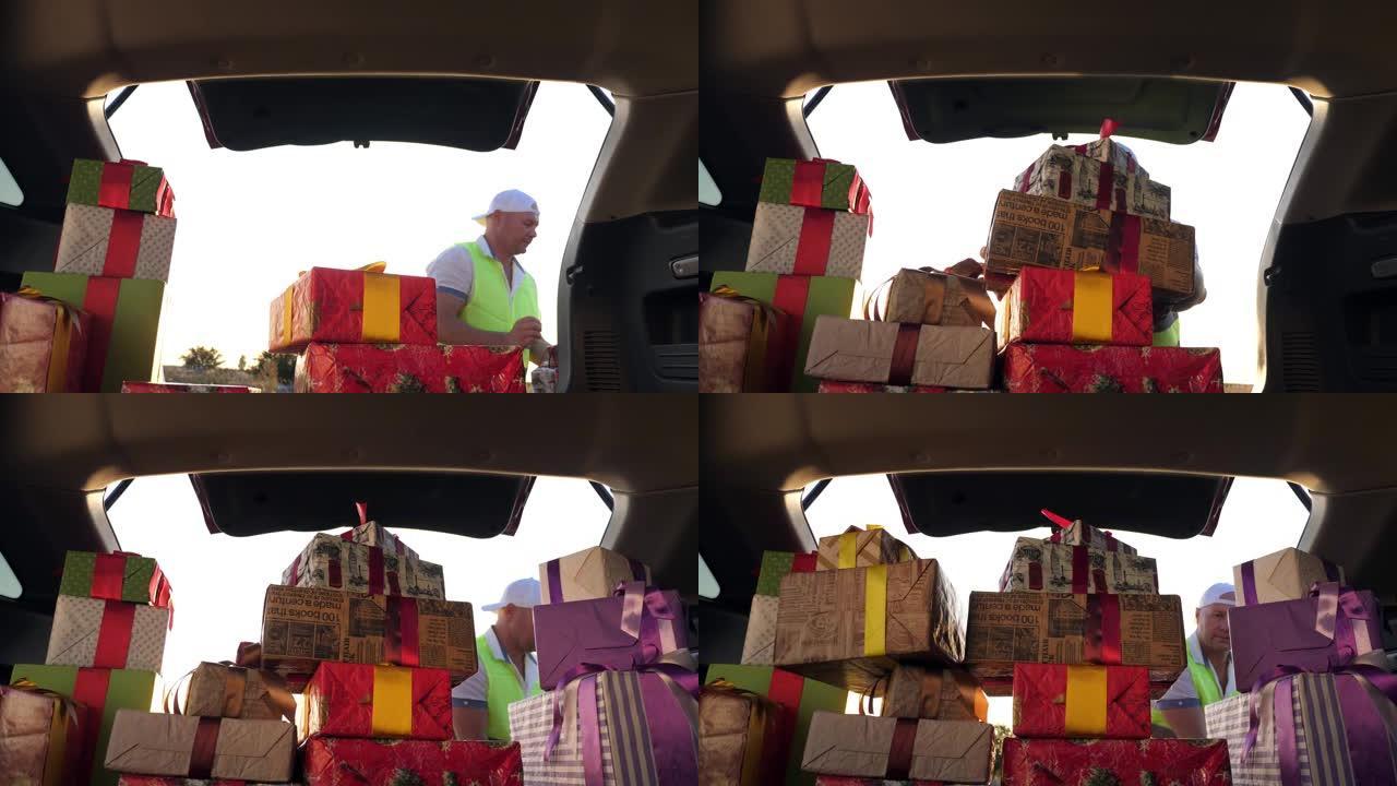 送货服务。送货员装载箱子。汽车中的礼品盒。包装精美的包裹。从车内看。捐赠、慈善或交付概念