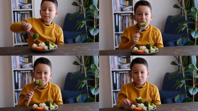爱吃蔬菜的孩子。他的盘子里有很多蔬菜。他喜欢蔬菜。