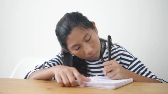 亚洲女孩在新型冠状病毒肺炎期间在家做作业，生活方式概念。