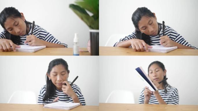 亚洲女孩在新型冠状病毒肺炎期间在家做作业，生活方式概念。
