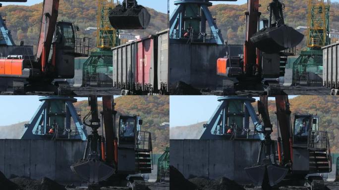 海运煤炭码头。装卸起重机使用大桶从铁路货车上卸下煤炭。