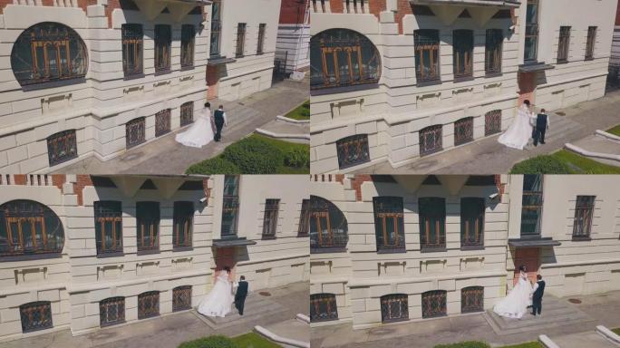 新娘和新郎走到美丽的建筑台阶鸟瞰图