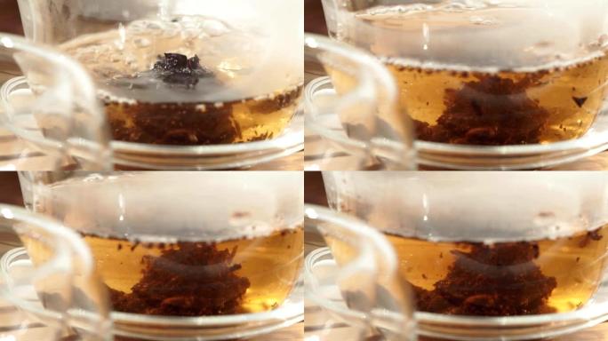 茶壶将红茶倒入玻璃杯中，特写微距，选择性聚焦