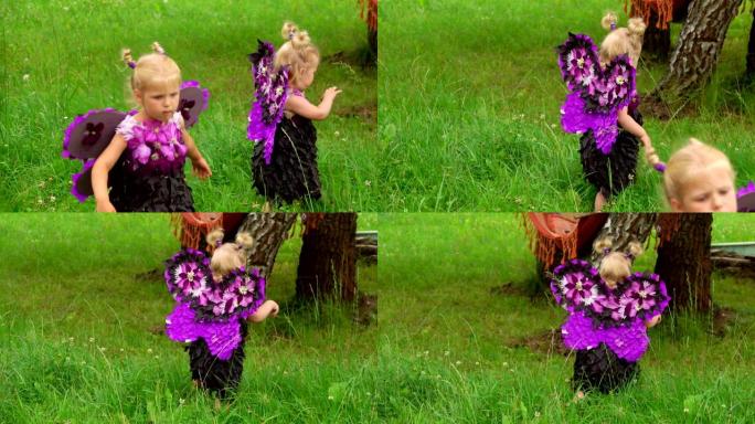 穿着蝴蝶服装的女孩在草坪上行走