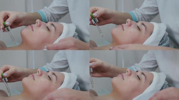 专业美容师妇女用移液管在楔形皮肤上涂油