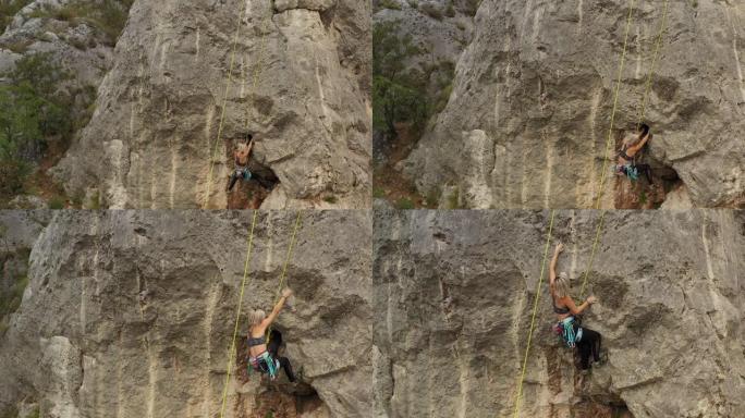 十几岁的女孩在岩石上练习自由攀爬