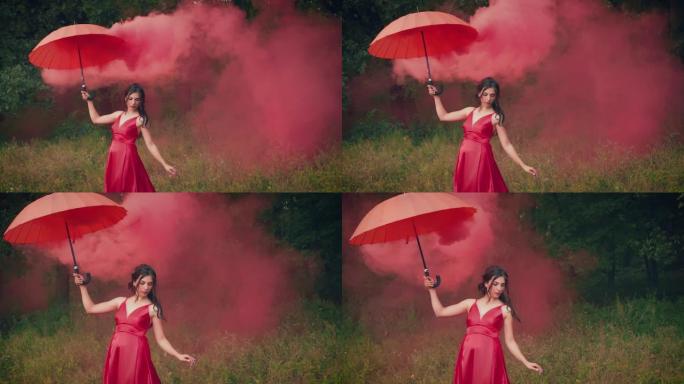 穿着红色连衣裙的美女，手里拿着雨伞。创意烟雾弹。