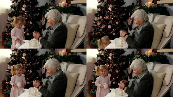 奶奶向女孩展示如何编织毯子