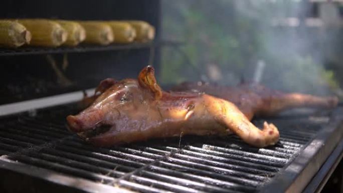 4K，烤肉架上的美味猪肉。全猪煮熟的烤肉特写。