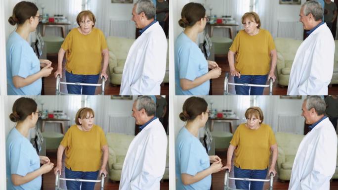 老年妇女与行动助行器在疗养院与医生和护士交谈