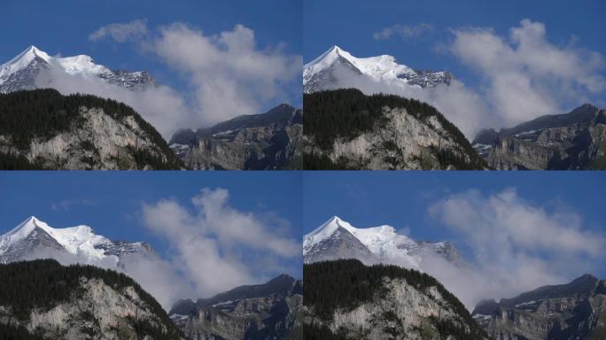 瑞士山脉景观，云彩在蓝色背景下掠过