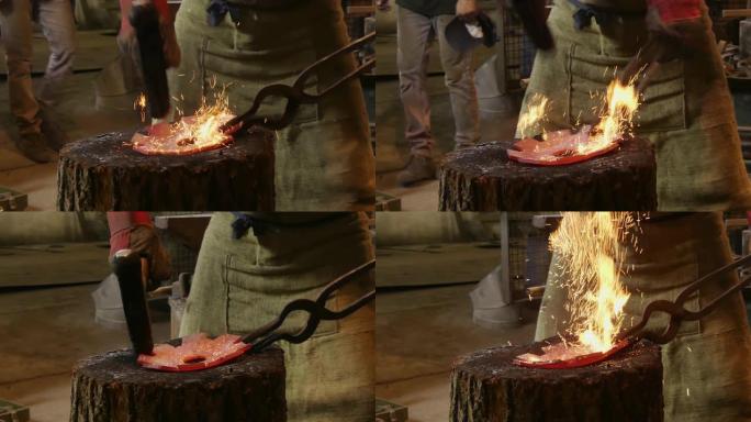 铁匠正在用锤子锻造金属。铁匠用火花烟花手动锻造铁匠铺铁砧上的熔融金属。特写