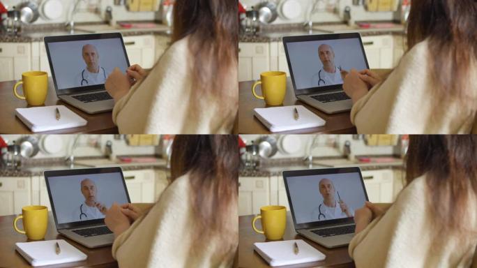 生病的女人在家里的笔记本电脑屏幕上进行视频通话时咨询医生。医生在远程会诊时解释诊断。远程医疗，而自我
