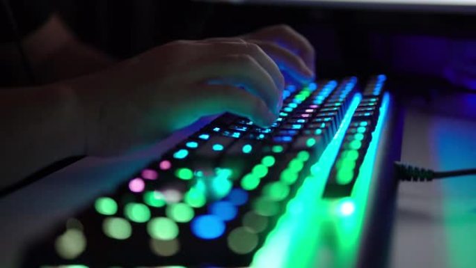 用手在发光二极管电脑键盘上打字。