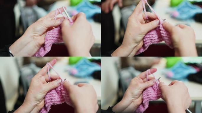 手工制作的传统针织。女人用缝衣针缝针。