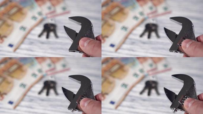 一个人的手在欧元钞票的背景上设置了一个可调节的扳手，并在白色的木桌上设置了钥匙。汽车维修的融资成本