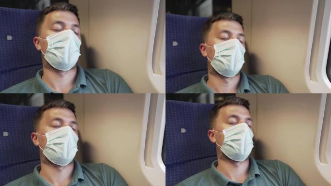 在冠状病毒大流行和流行期间，乘火车旅行的白人男性乘客，疲倦并睡在靠窗的座位上。旅行者戴防护口罩抵御C