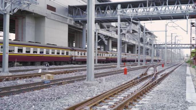 泰国当地的老经典火车或有轨电车在城市的公共交通，能源电气技术和工业概念的终点站与电线杆塔和电缆线在铁