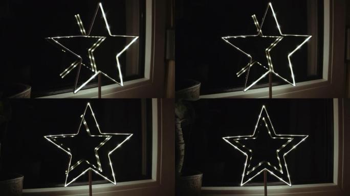 点燃的圣诞星星，窗户上有反射
