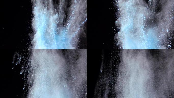 彩色蓝色粉末在黑暗孤立背景上的超慢动作爆炸。粉末团向上飞，与烟雾混合。