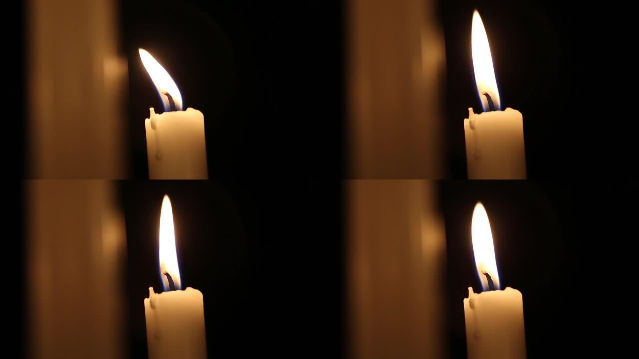 火焰蜡烛特写在一个黑色的背景。