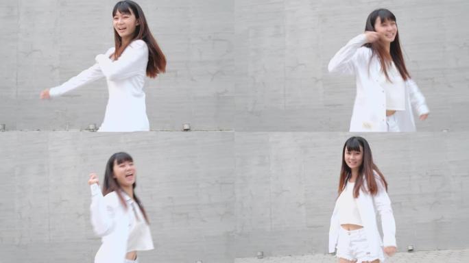 漂亮的亚洲女孩在街上跳舞