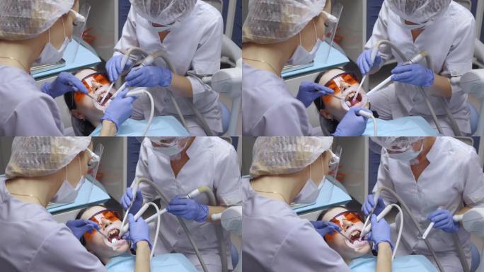 牙医在牙科诊所进行手术，患者在全身麻醉下躺在桌子上