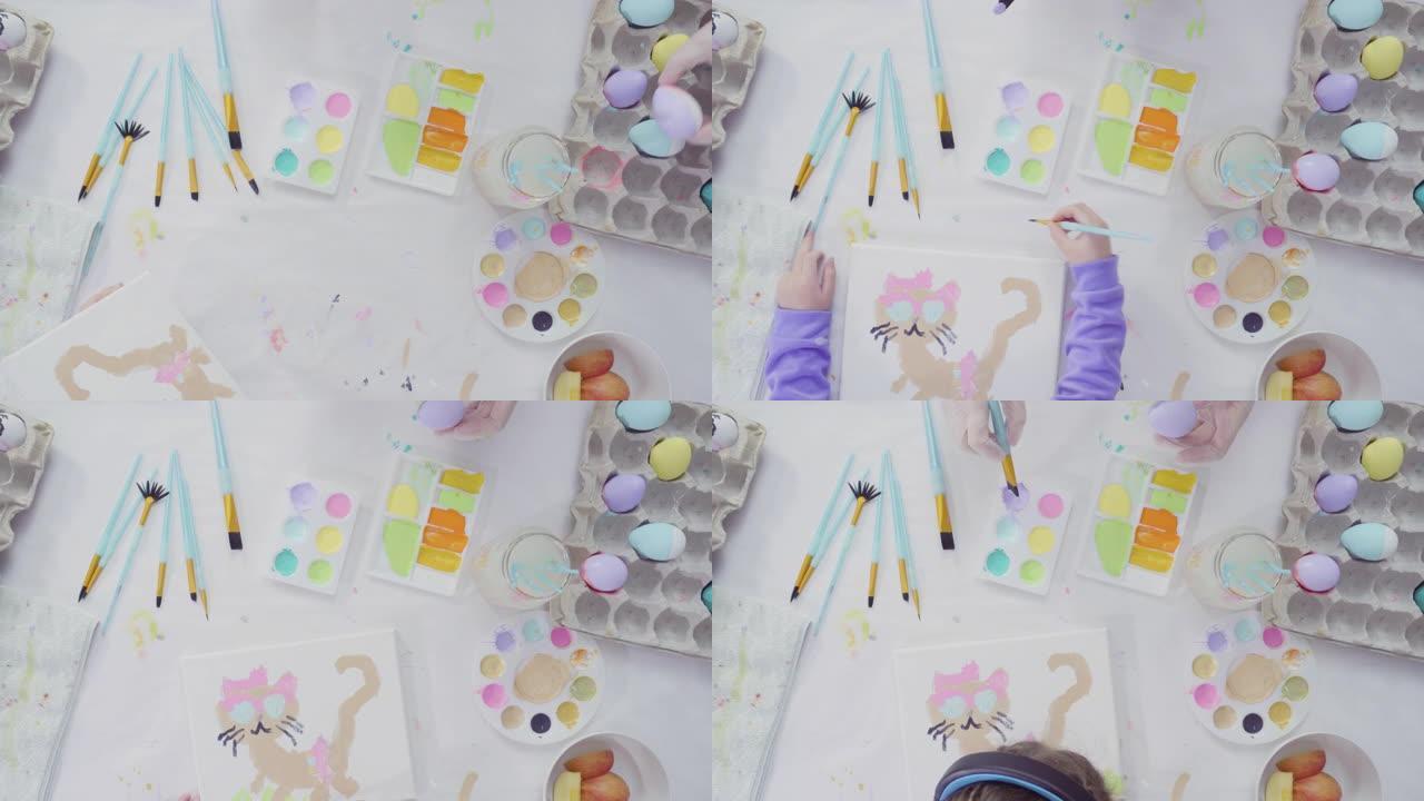 小女孩和她妈妈用丙烯酸涂料绘画复活节艺术项目。