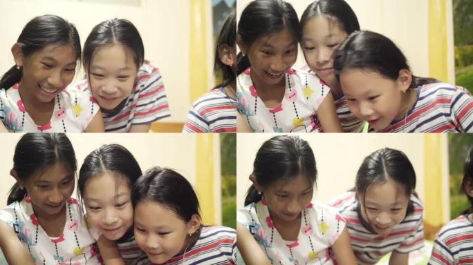 快乐的亚洲儿童在家里，生活方式和技术概念一起通过智能手机拍照。