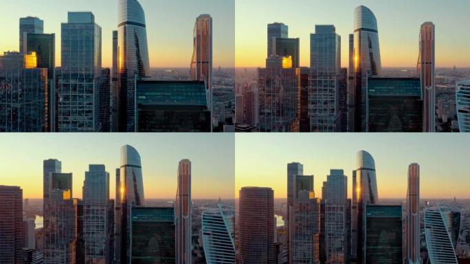 日落时未来派莫斯科国际商务中心的航拍。金融区摩天大楼。成功的概念。摄像机正在倒退