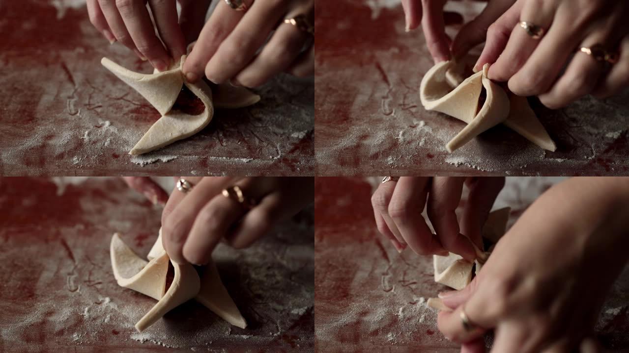 用果酱形成饼干的手。自制甜点。