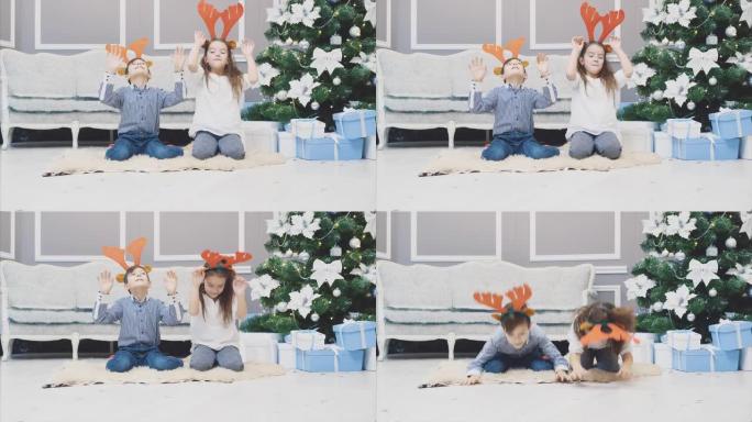 有趣的视频，兄弟姐妹戴着圣诞节驯鹿鹿角，在他们面前鞠躬，微笑着，看起来很可笑。